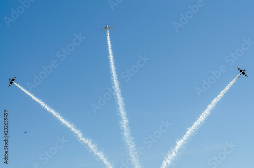 Planes in the blue sky and their white traces