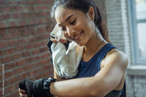 Asian girl exercising in gym she tired and She has sweat on her face. photo