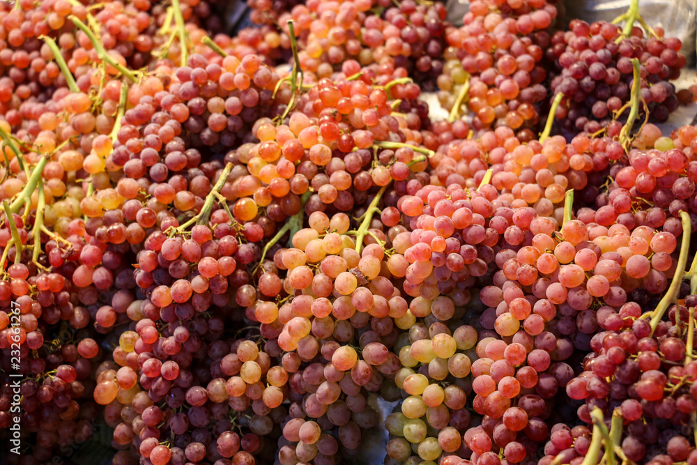 Red grapes,healthy fruits on the counter of the market in Qazvin, north-west Iran Red grapes,healthy fruits on the counter of the market in Qazvin, north-west Iran
