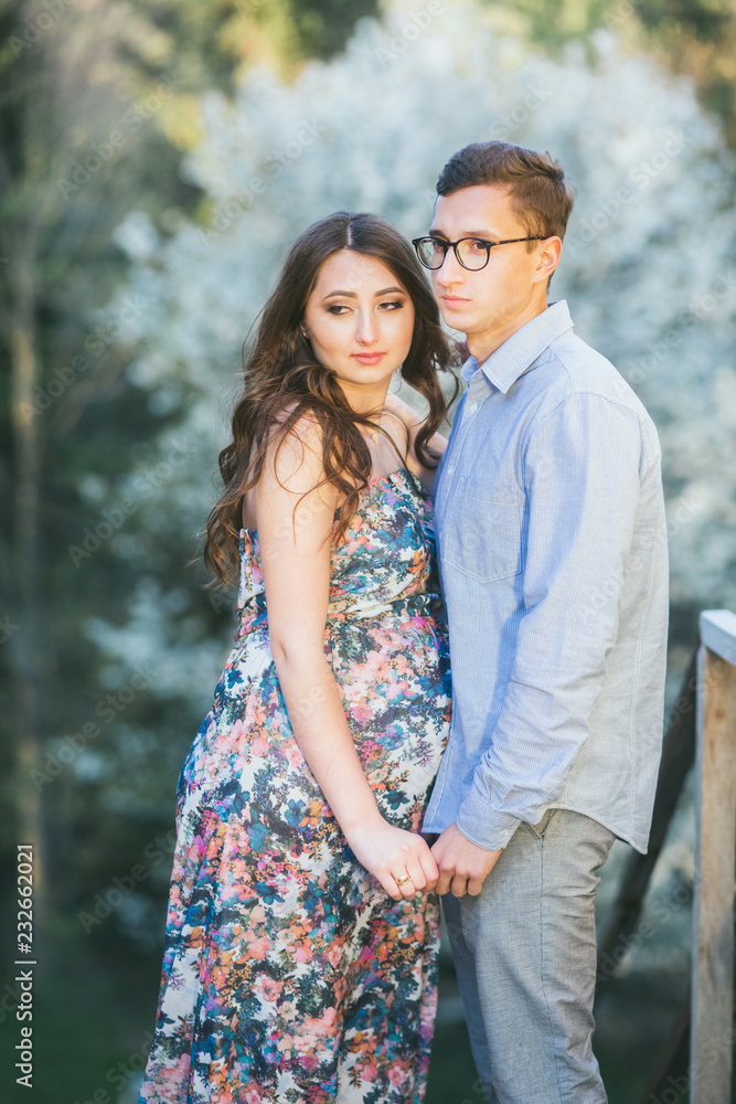 Romantic summer love story on a sunset in mountains. Young girl and boy in love. pregnant women Romantic summer love story on a sunset in mountains. Young girl and boy in love. pregnant women
