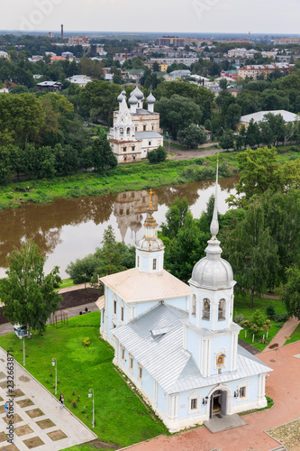 Flight of the camera over Saint Sophia orthodox cathedral and church of Resurrection of Jesus in a sunny summer day in Vologda Kremlin photo