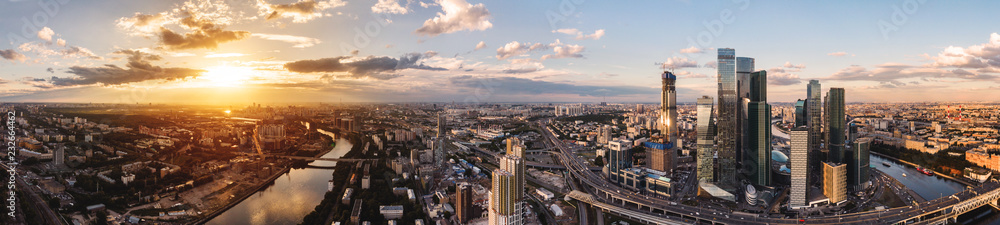 high-rise buildings and transport of metropolis, traffic and blurry lights of cars on multi-lane highways and road junction at sunset in Moscow high-rise buildings and transport of metropolis, traffic and blurry lights of cars on multi-lane highways and road junction at sunset in Moscow