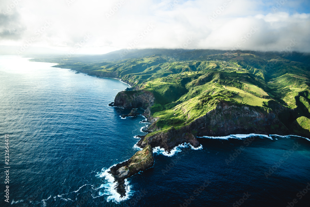 Beautiful Aerial View of Tropical Island Paradise Nature Scene of Maui Hawaii On Clear Sunny Day with Vibrant Blue Ocean Water and Waves and Lush Green Mountain Scenic Landscape 