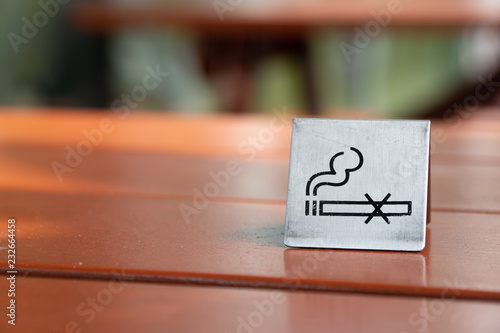  No smoking sign displayed on a wood table in the restaurant