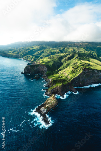 Beautiful Aerial View of Tropical Island Paradise Nature Scene of Maui Hawaii On Clear Sunshine Blue Sky Day with Vibrant Blue Ocean Water and Waves and Lush Green Mountain Scenic Landscape 