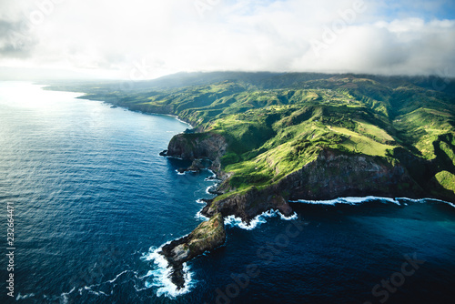 Beautiful Aerial View of Tropical Island Paradise Nature Scene of Maui Hawaii On Clear Sunny Day with Vibrant Blue Ocean Water and Waves and Lush Green Mountain Scenic Landscape © Lucas