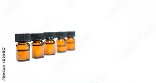 Small brown medical bottles in row isolated on white background, space for tesxt. photo