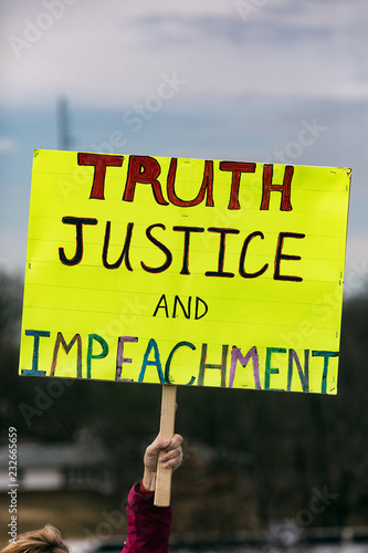 Protest: Person Holds Up Sign Calling For Impeachment photo