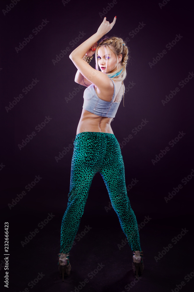 Young fashionable girl in disco style. Listening music and enjoying. Retro style
