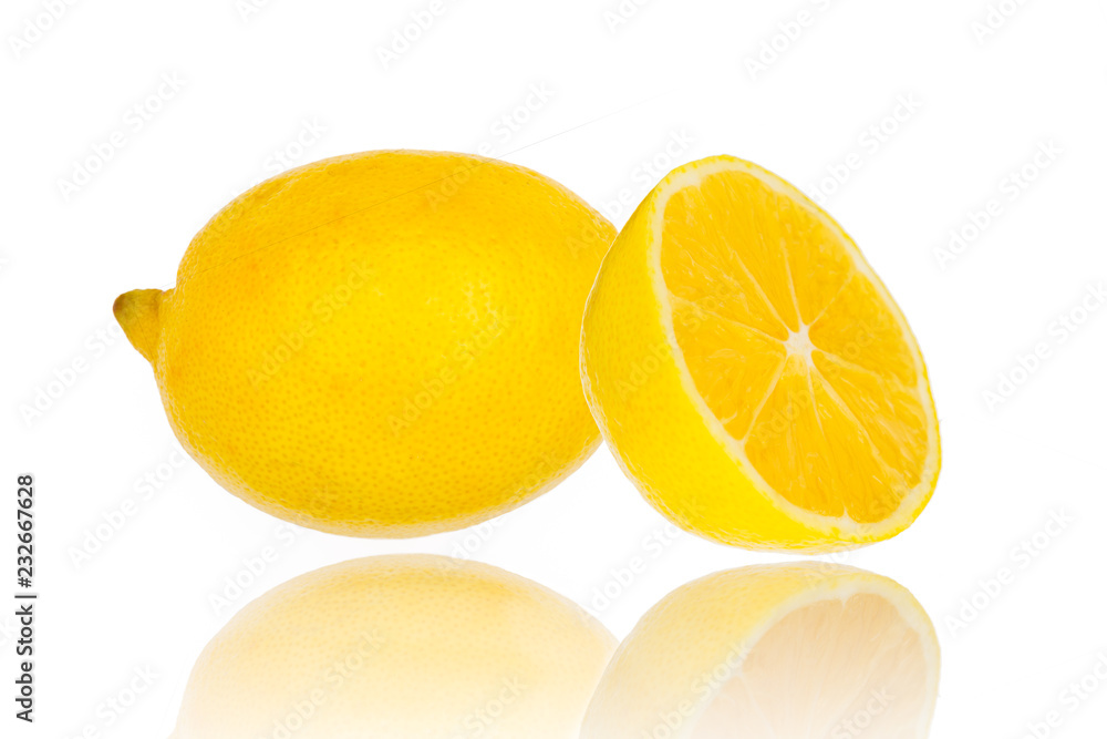 Fresh lemon with half isolated on white with mirror reflection on surface Fresh lemon with half isolated on white with mirror reflection on surface