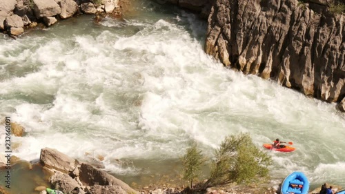 Kayak in white water rapids -wide shot from above photo