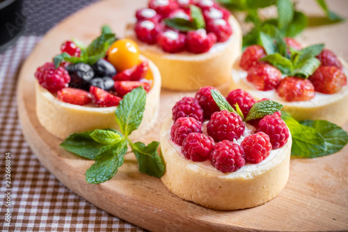 raspberry cake with cream cheese, mint on crumbly dough. Cake with raspberries