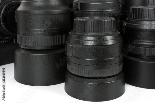Collection of professional and modern lenses and DSLR camera in close-up.