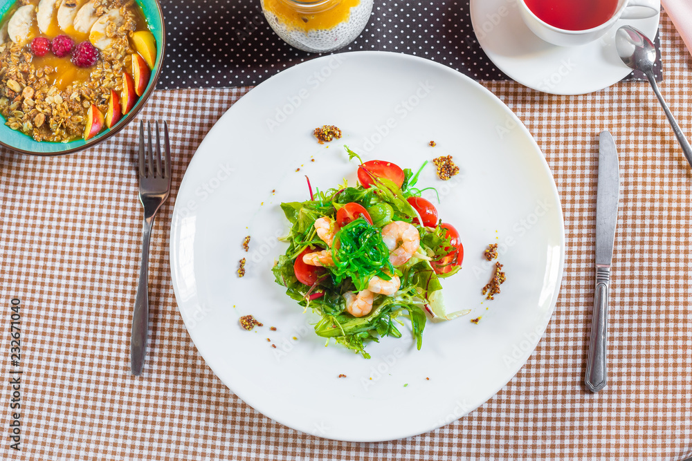 Salad with shrimps, arugula, algae, tomatoes and greens Salad with shrimps, arugula, algae, tomatoes and greens