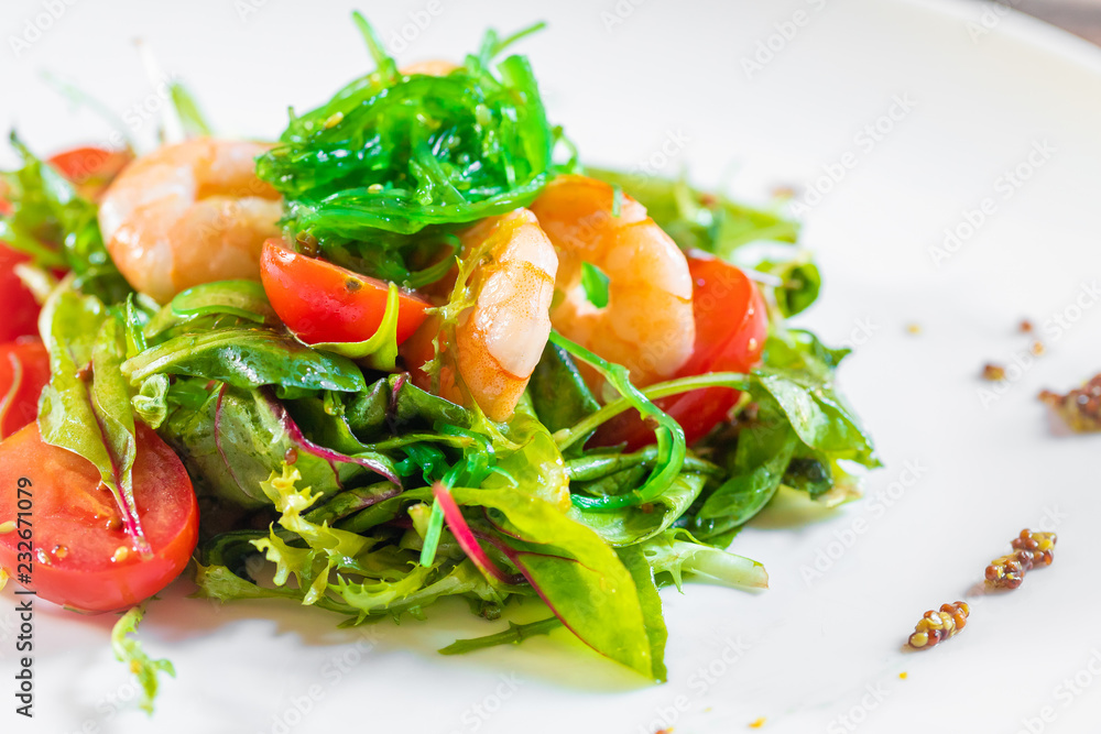 Salad with shrimps, arugula, algae, tomatoes and greens Salad with shrimps, arugula, algae, tomatoes and greens