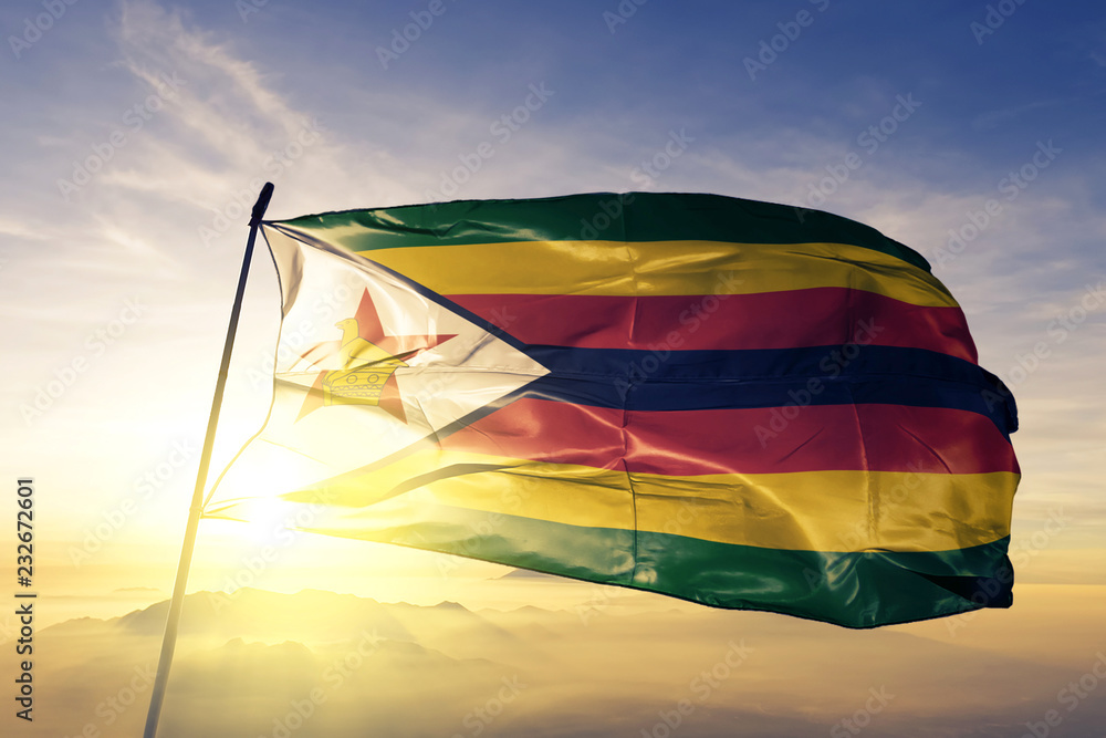 Zimbabwe zimbabwean flag textile cloth fabric waving on the top sunrise mist fog