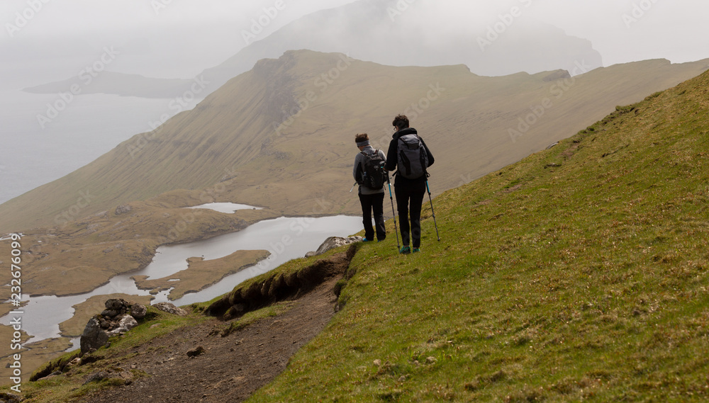 Group of friends exploring the beautiful highlands of Faroe Islands