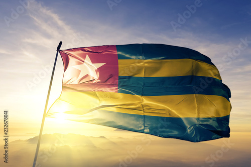 Cuadro en lienzo Togo togolese flag textile cloth fabric waving on the top sunrise mist fog
