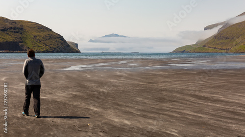 Man exploring the beaches in Faroe Islands
