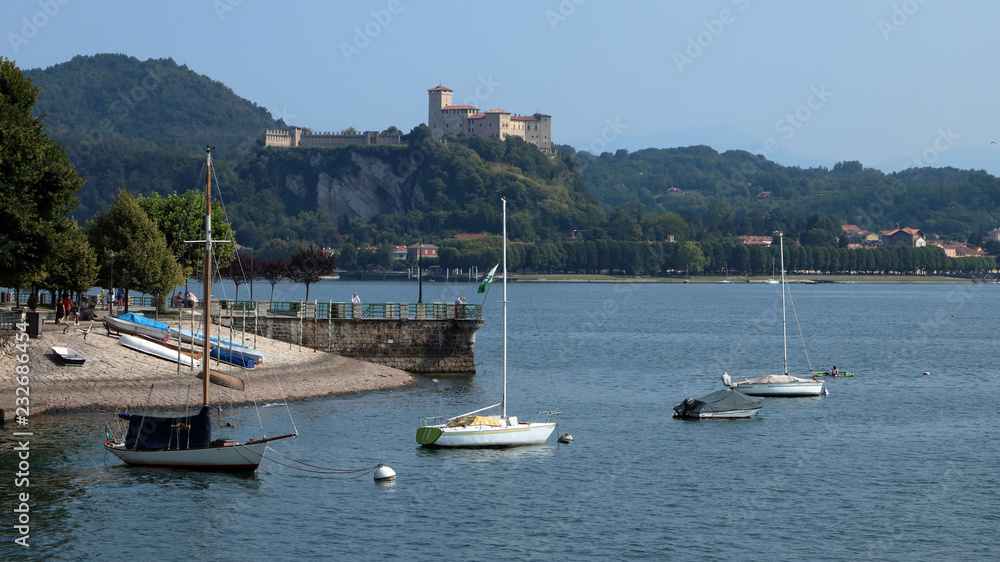 lago maggiore con barche e rocca di angera in italia, maggiore lake with boats and angera fortress