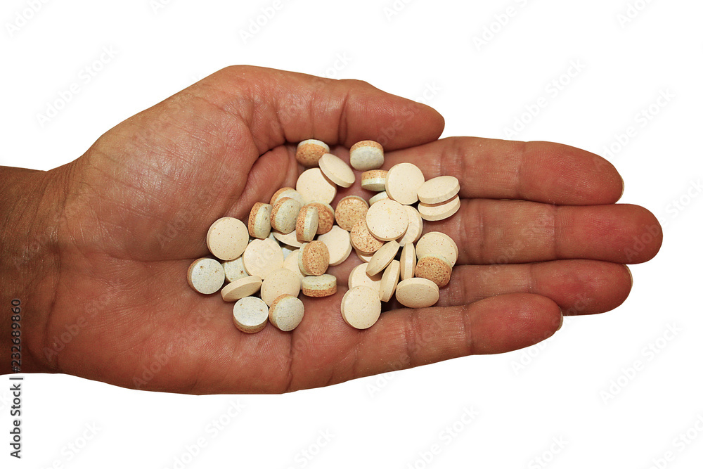 Handful of pills in palm on white background, close-up. Assorted medication in hand. Advertising healthy lifestyle, but also possibility of addiction to medication and overdose. Horizontal. Handful of pills in palm on white background, close-up. Assorted medication in hand. Advertising healthy lifestyle, but also possibility of addiction to medication and overdose. Horizontal.