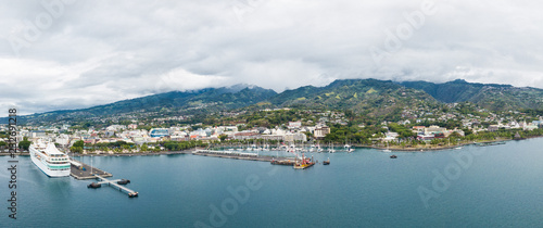 Papeete, Tahiti, French Polynesia. Aerial view of city skyline, sea port and marine from sea in a cloudy weather. Tahiti and her islands.