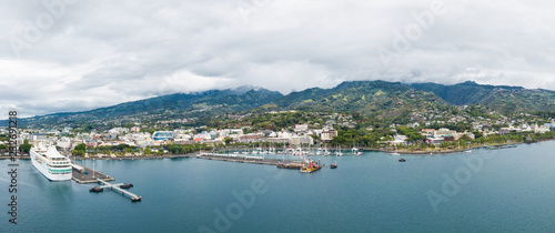 Papeete, Tahiti, French Polynesia. Aerial view of city skyline, sea port and marine from sea in a cloudy weather. Tahiti and her islands. photo
