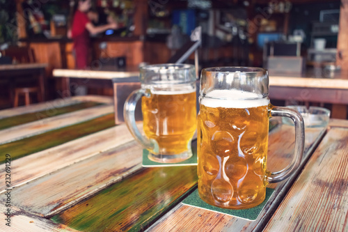 Canvas Print Glasses of light beer on pub background