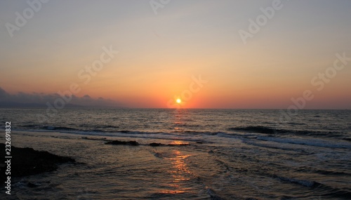 Sunset view at black sea coast  in summer  wavy beach