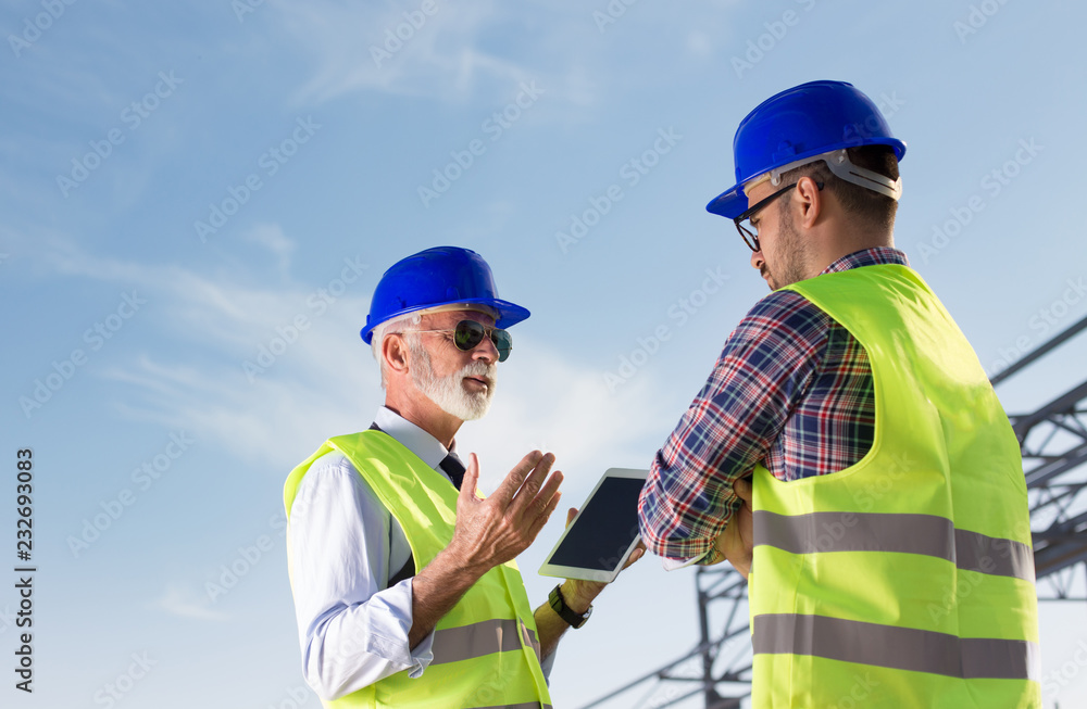 Engineer and construction worker at building site Engineer and construction worker at building site