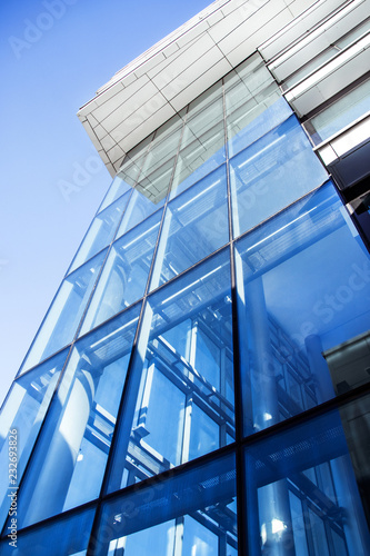 blue glass wall of modern office building.