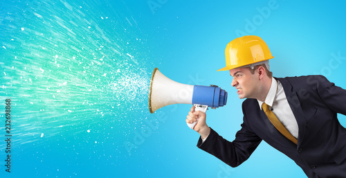 Young architect constructor yelling with megaphone and sparkling sounds 