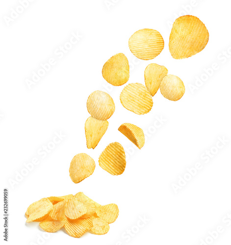 Tasty ridged potato chips on white background