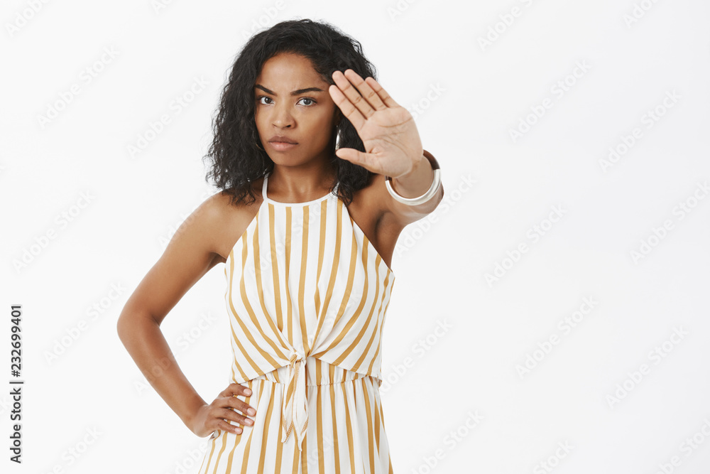 No photos. Portrait of serious-looking intense and moody bothered african american woman pulling hand towards camera to cover face from camera standing dissatisfied wanting reduce attention No photos. Portrait of serious-looking intense and moody bothered african american woman pulling hand towards camera to cover face from camera standing dissatisfied wanting reduce attention