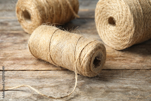 Natural hemp rope spools on wooden table