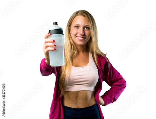Pretty sport woman with a bottle of water on isolated white background