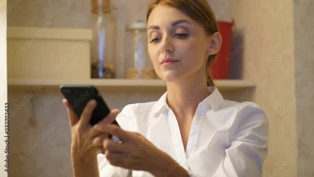Woman with smartphone take off modern headphones Woman with smartphone take off modern headphones