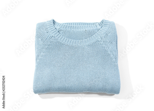 Folded cozy warm sweater on white background, top view