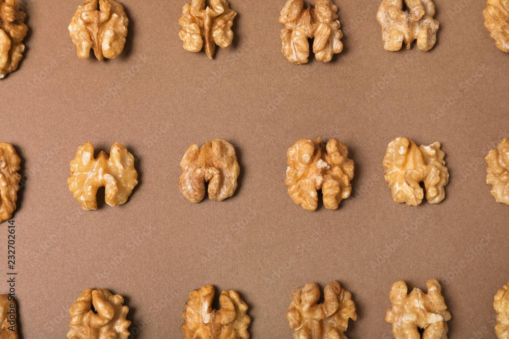 Tasty walnuts on color background, flat lay Tasty walnuts on color background, flat lay