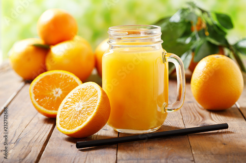 Bild auf Leinwand glass jar of fresh orange juice with fresh fruits