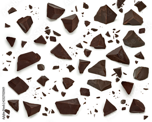 Broken, cracked or crushed dark chocolate parts from top view isolated on white background