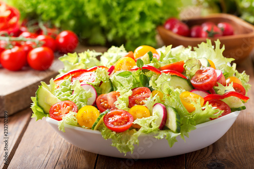 bowl of fresh salad with vegetables and greens photo