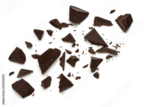 Broken, cracked or crushed dark chocolate parts from top view isolated on white background