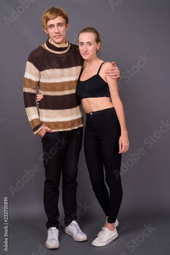 Studio shot of young couple together against gray background
