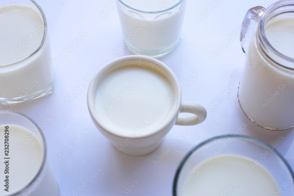 Cup and glass of milk on white background Cup and glass of milk on white background