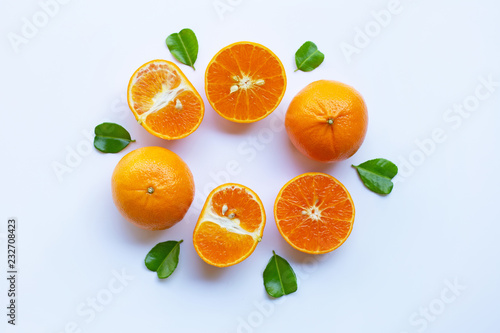 Fresh oranges with half of Bergamot kaffir lime leaves, heart shape on white background