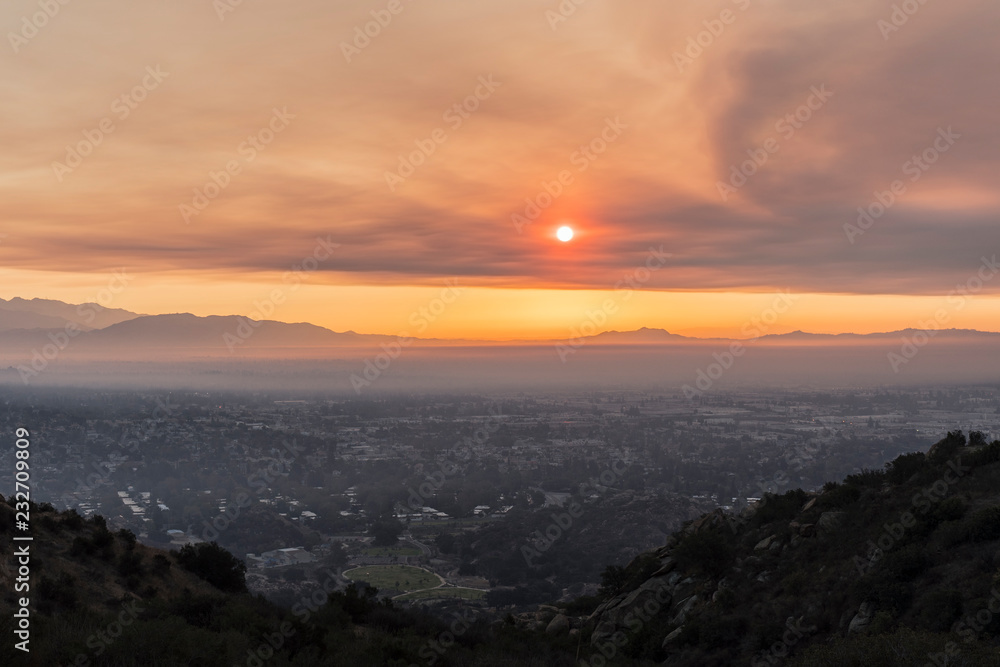Los Angeles, California, USA - November 10, 2018:  Smoke filled sunrise sky above the San Fernando Valley.  Smoke is from the Woolsey fire in Malibu and Ventura County.   