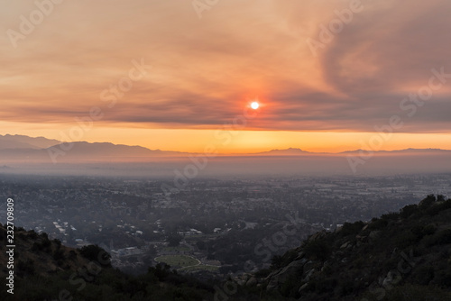 Los Angeles, California, USA - November 10, 2018: Smoke filled sunrise sky above the San Fernando Valley. Smoke is from the Woolsey fire in Malibu and Ventura County. 