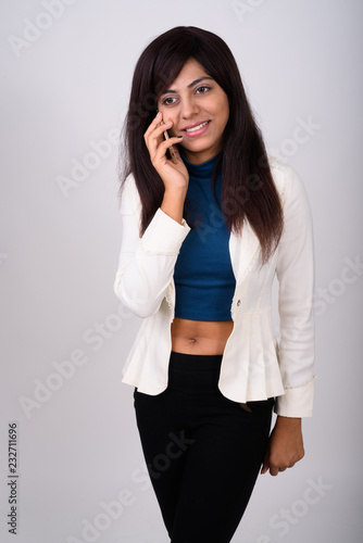 Studio shot of thoughtful young happy Persian businesswoman smil