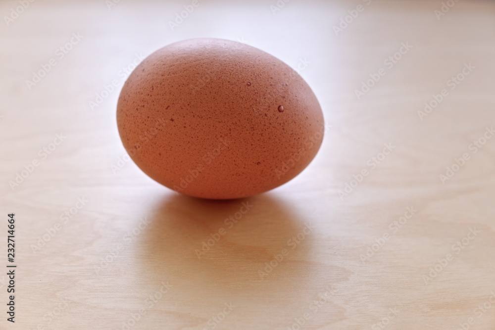 brown egg on wooden background brown egg on wooden background
